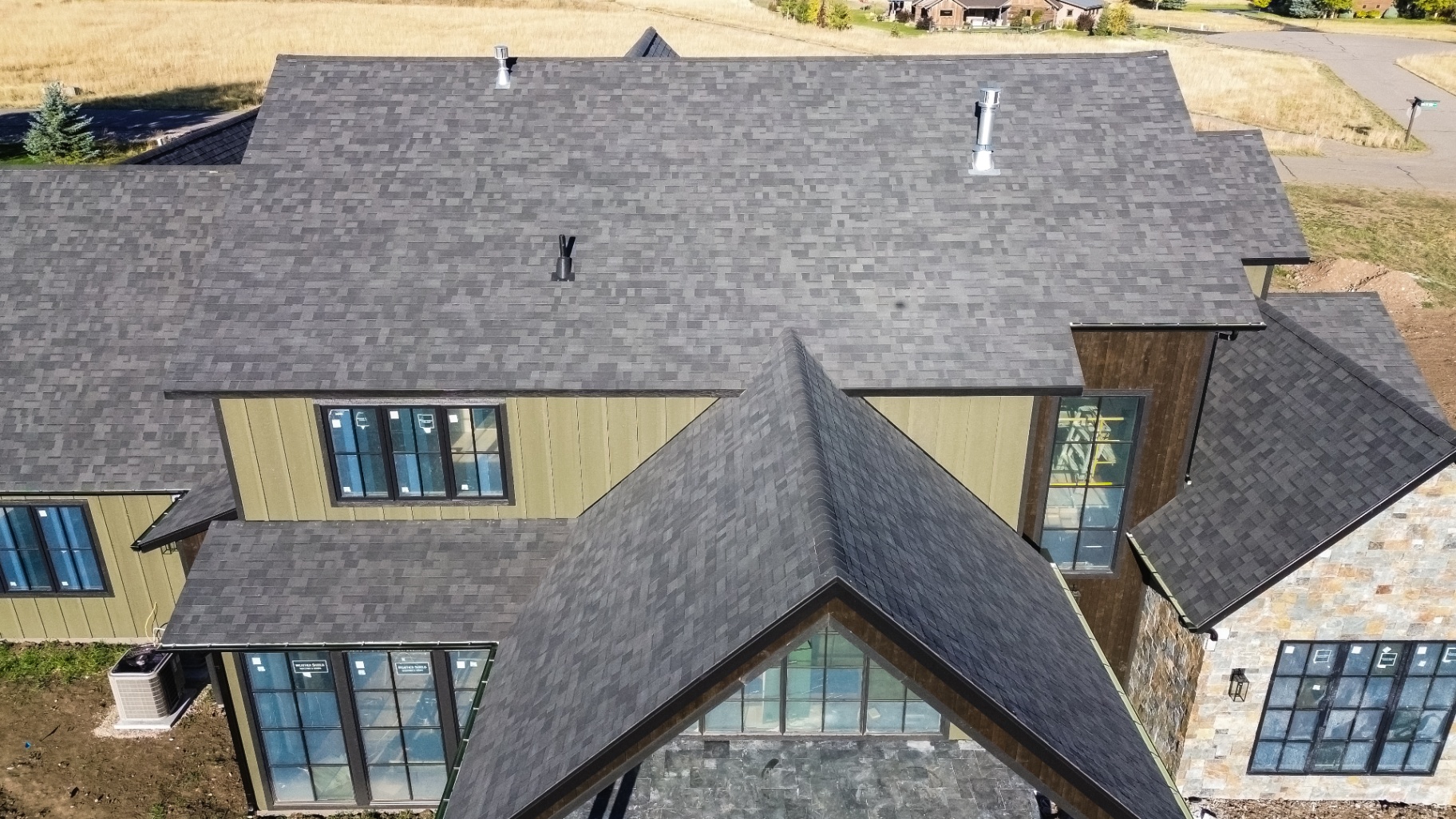 Detail of intersecting rooflines and fresh shingle work