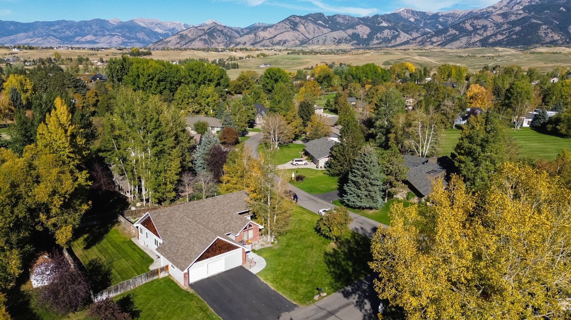 Wide aerial of Bozeman home with Bridger Mountain backdrop