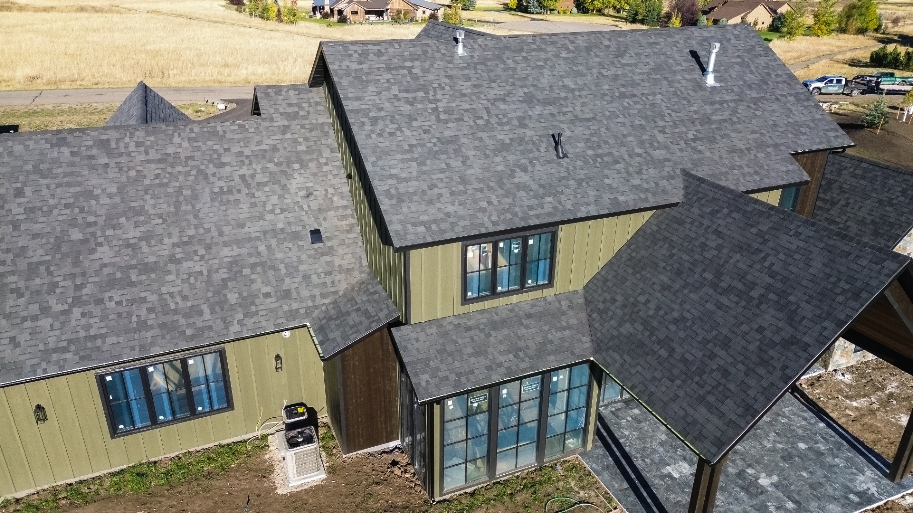 Aerial of multi-gable roof with mixed siding